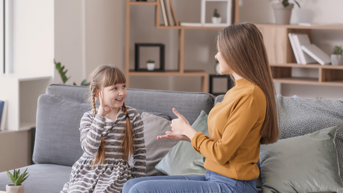 Mother and daughter using sign language together at home