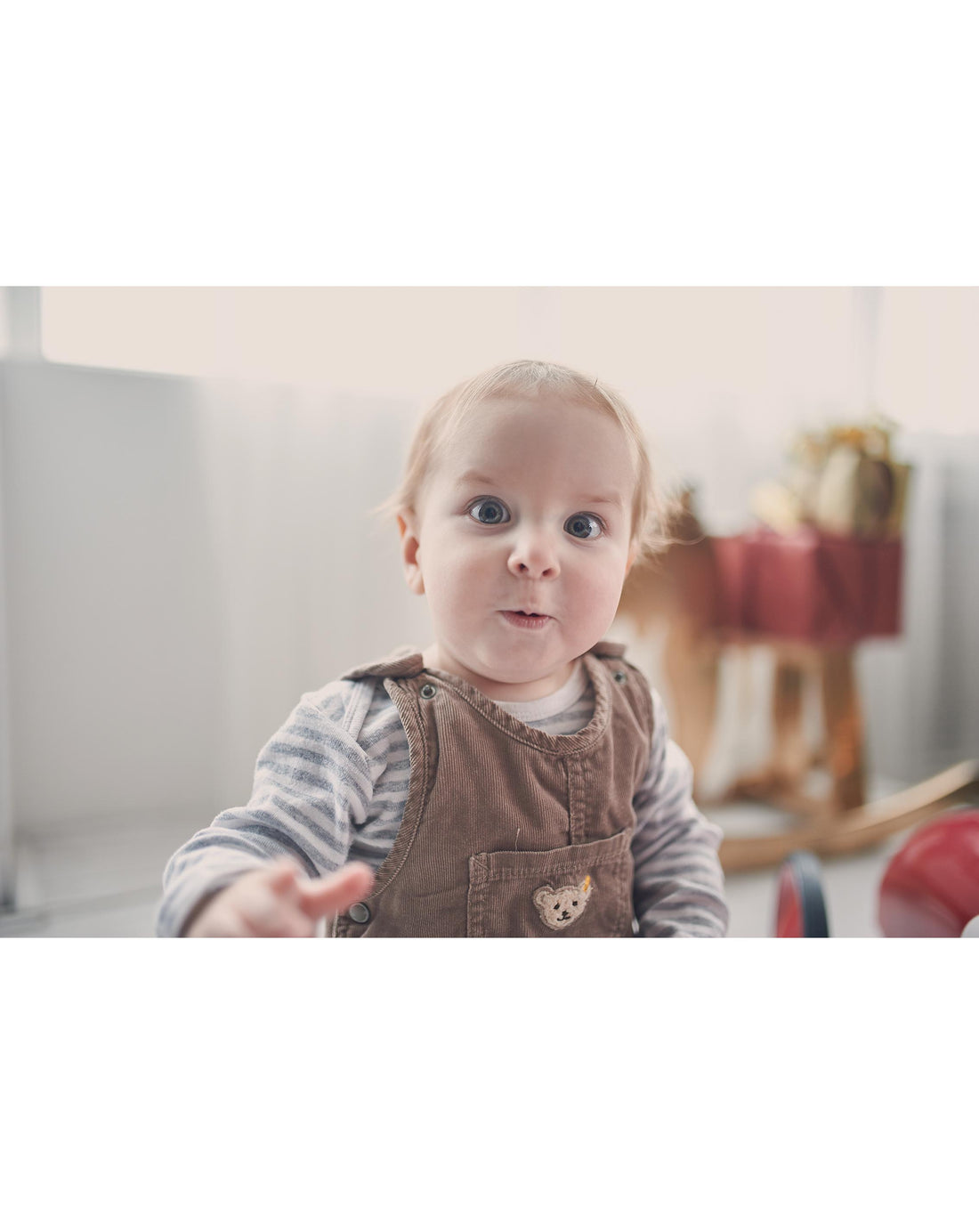 Portrait of a one year old baby boy sitting on the floor