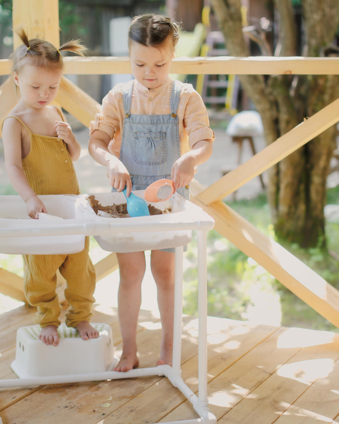 Children playing with sand and water in Montessori sensory baskets