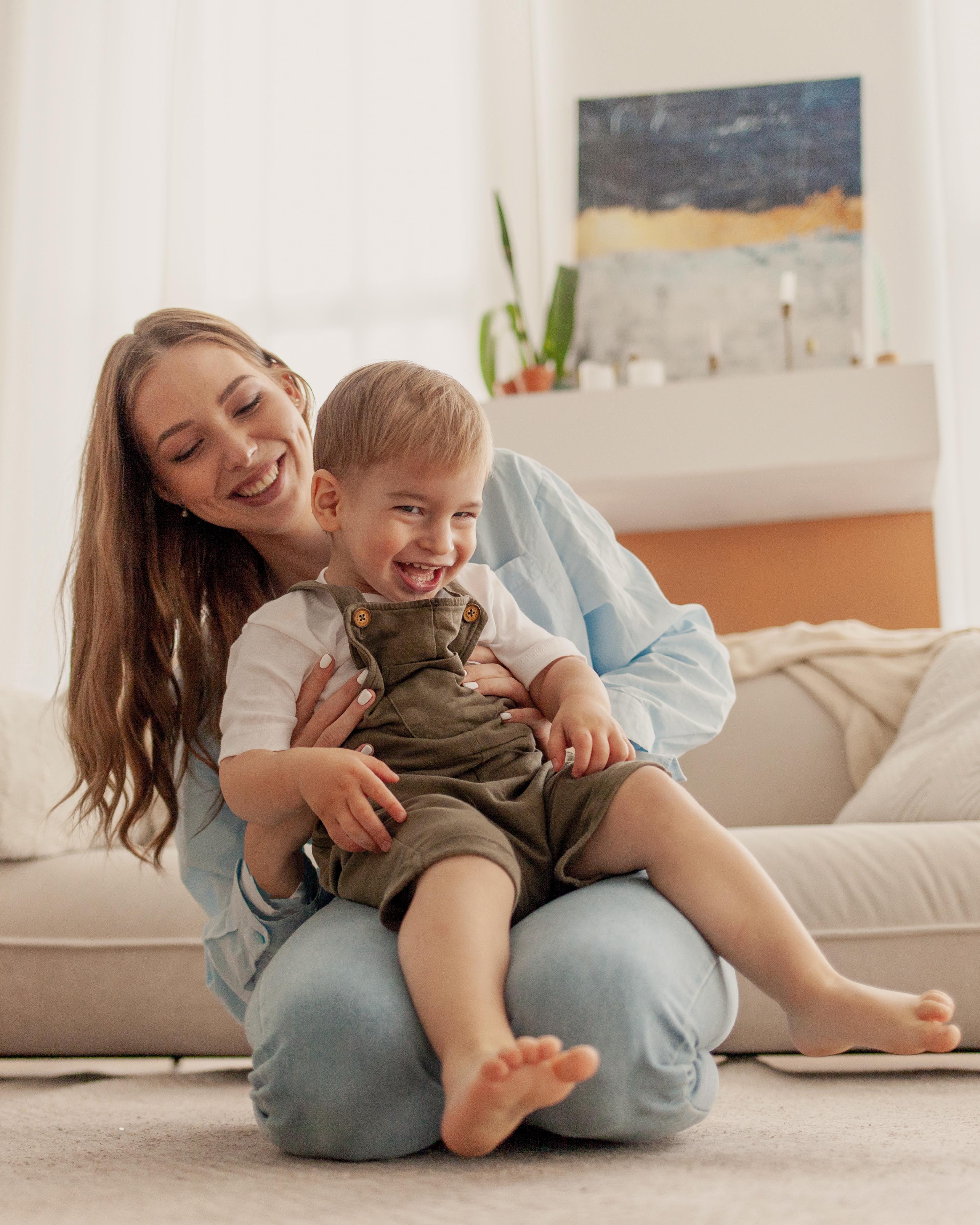 Mother playing with her two-year-old son at home for a practical weekly speech plan