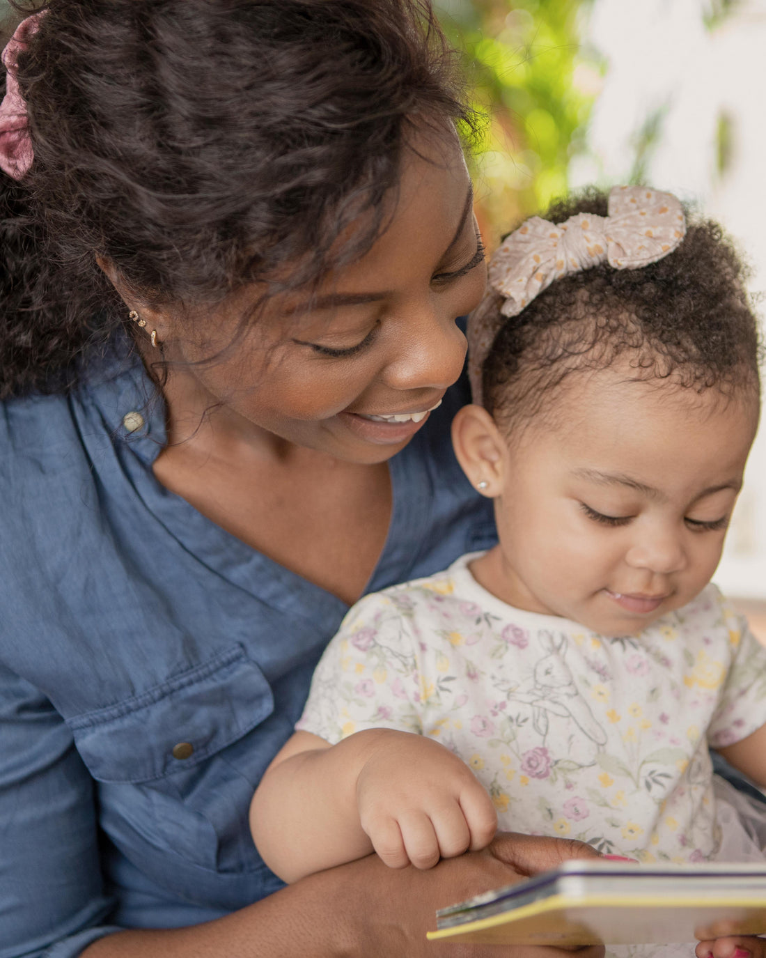Mother reading a book with her baby, calm and reassuring