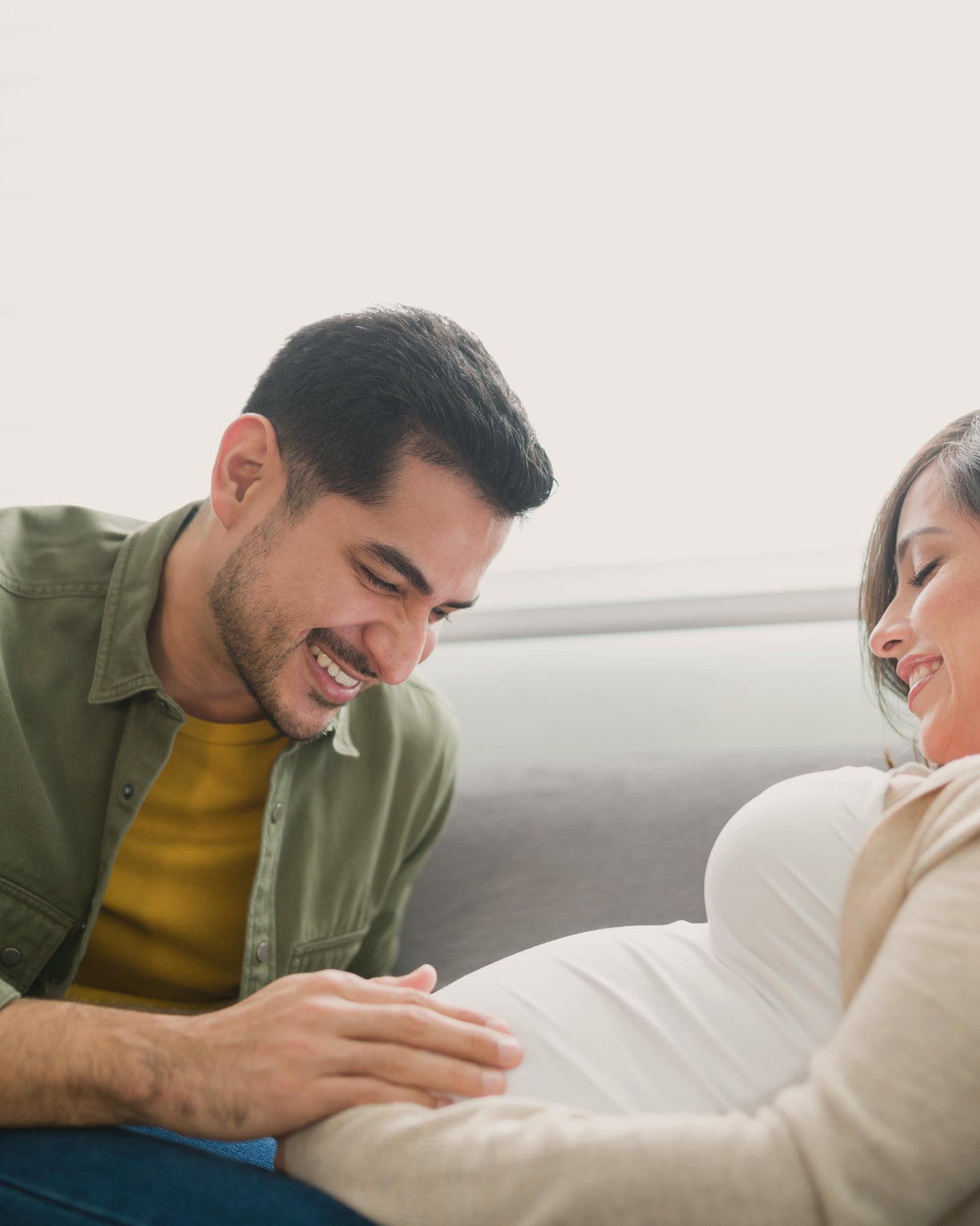 Pregnant couple relaxing together at home