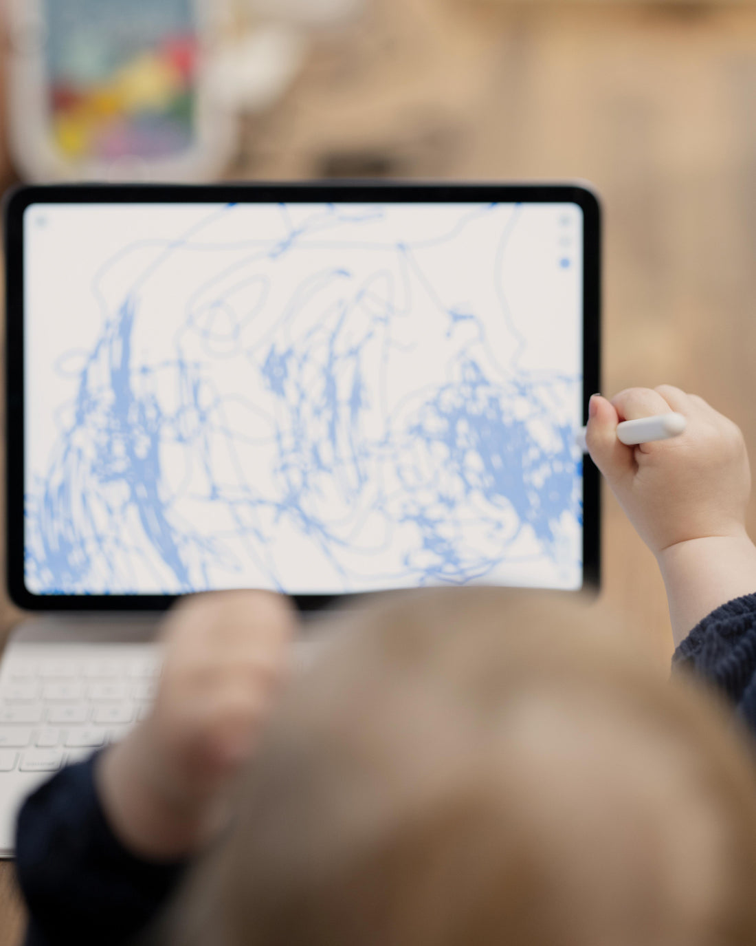 Girl drawing on a digital tablet from above