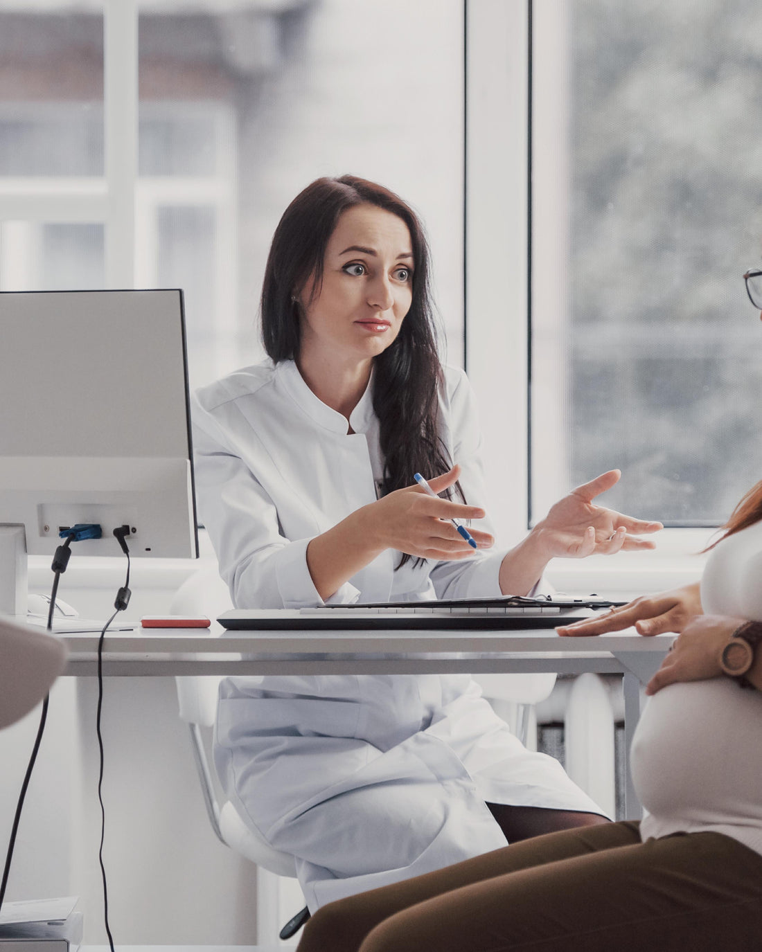 Pregnant woman having a consultation with her obstetrician