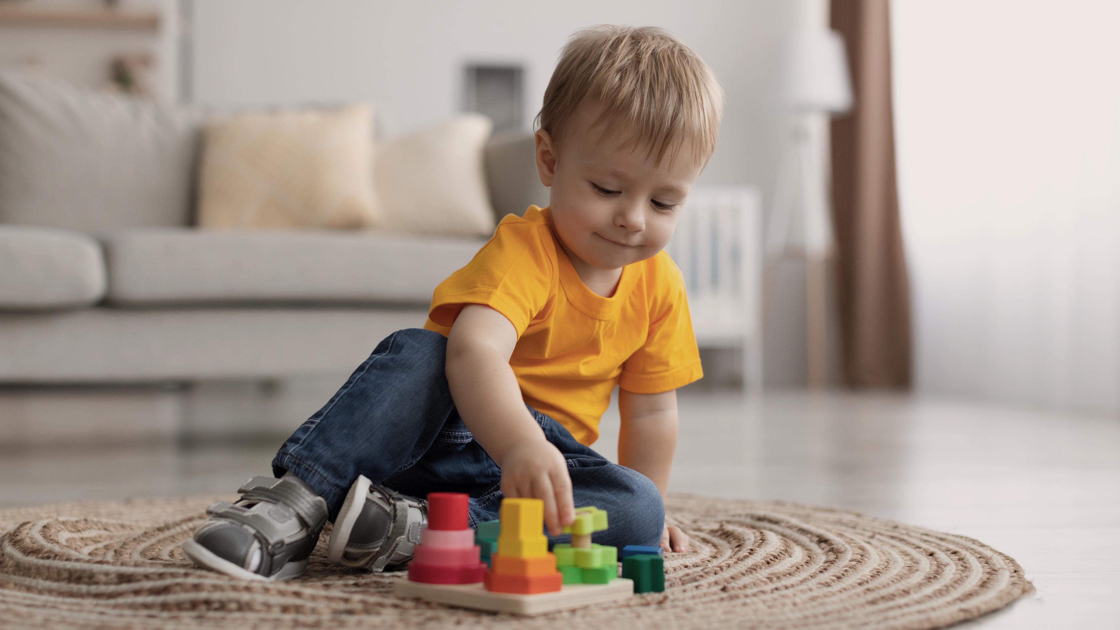 Toddler exploring a colorful wooden educational toy on the living room floor