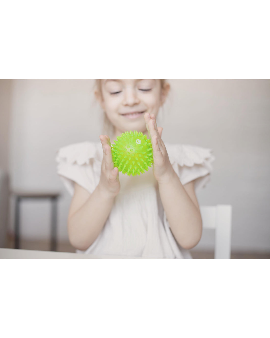 Child engaging with a tactile sensory relief ball