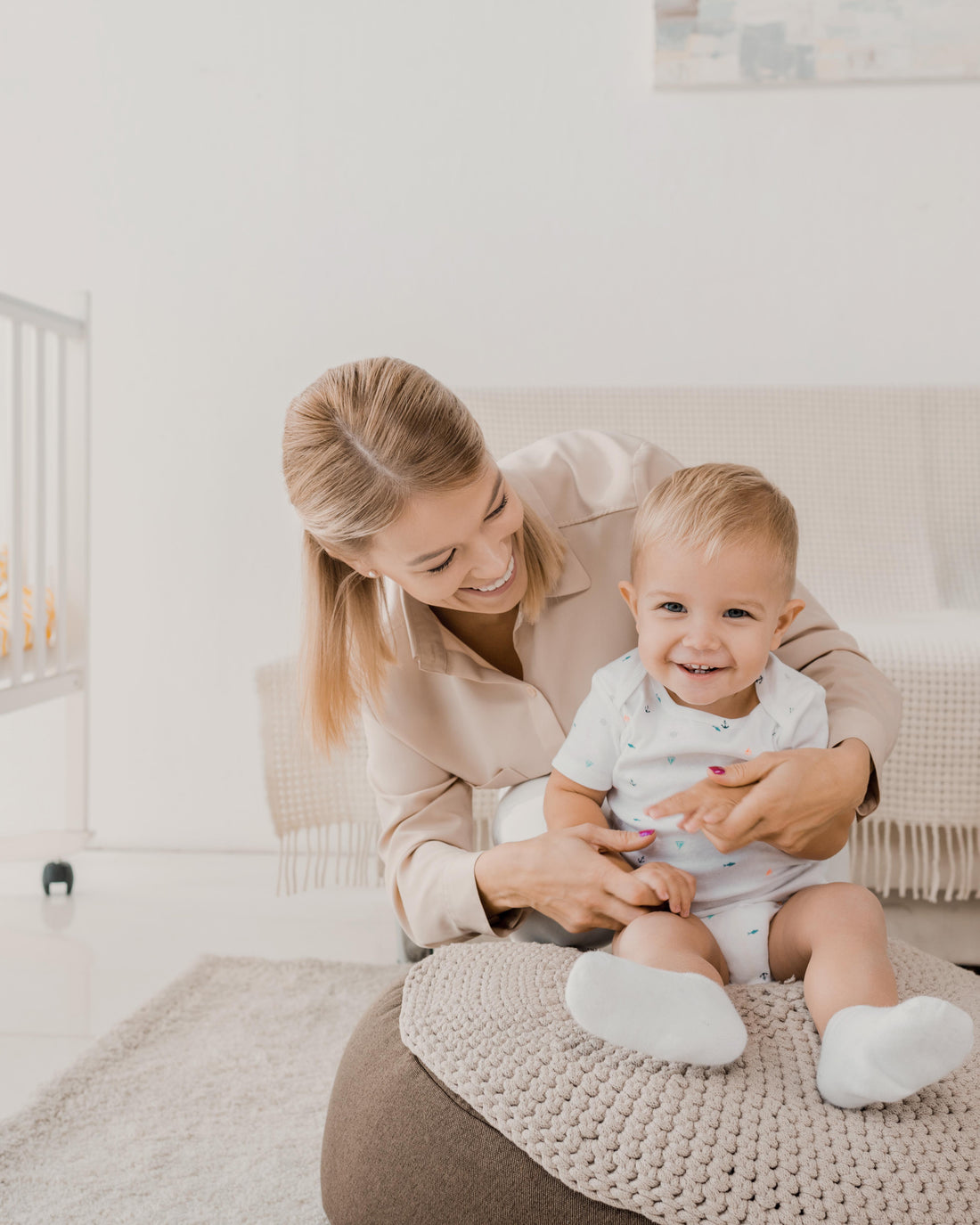 Toddler having fun with mother in the nursery room