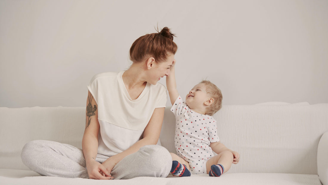 Mother and toddler son playing together on a cozy weekend morning