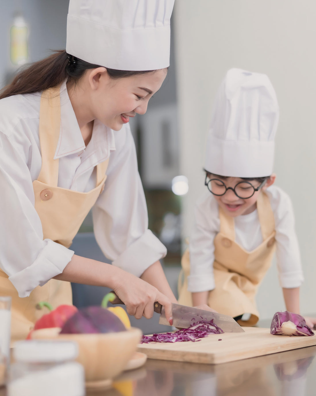 Mother teaching her son to cook in the kitchen