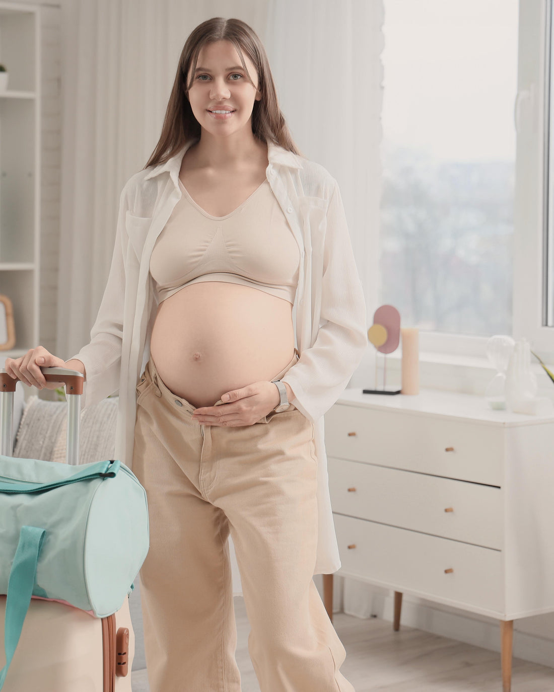 Pregnant woman with a packed hospital bag at home