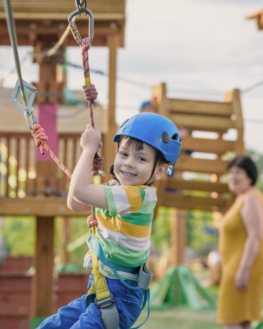 Active young boy playing at a climbing adventure park