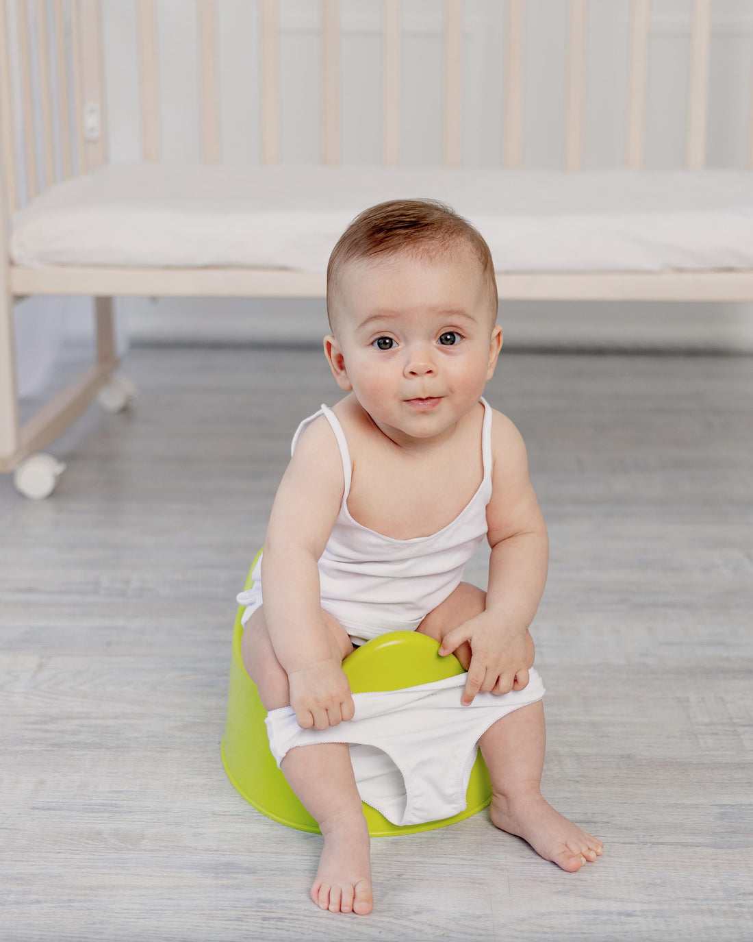 Baby girl sitting on a potty