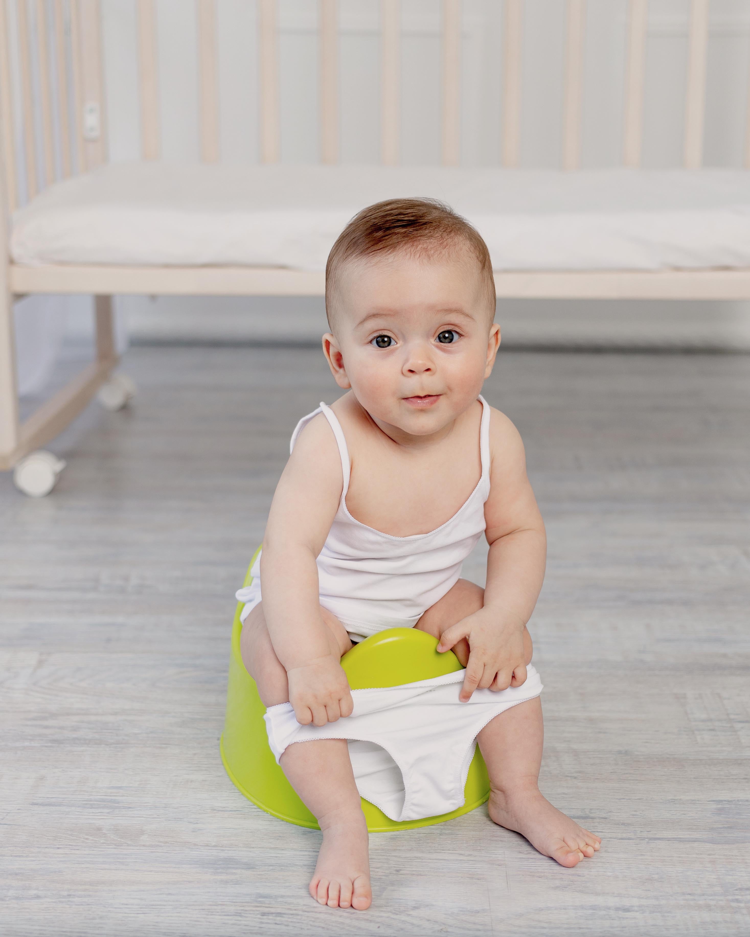 Baby girl sitting on a potty