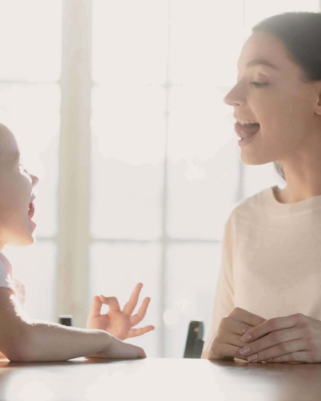 Child doing speech therapy exercises at home with a therapist